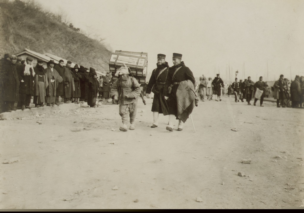 Korean Laborer Carries Medical Supplies from Shore with Japanese Soldiers1904.jpg